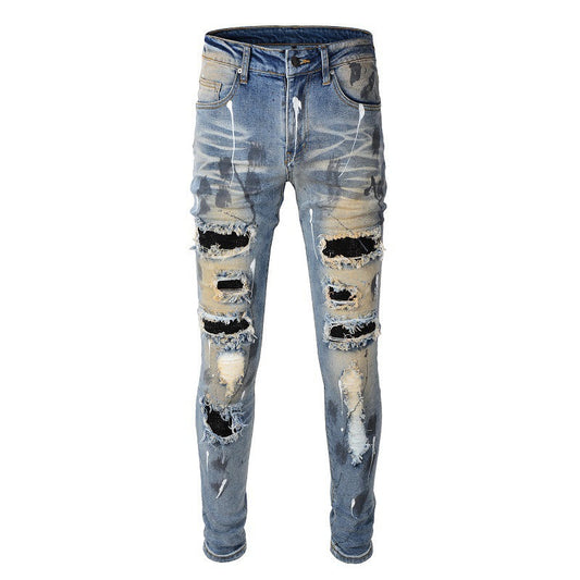 Men's Blue Jeans with Black Patches, Distressed Paint, and Ripped Details 523